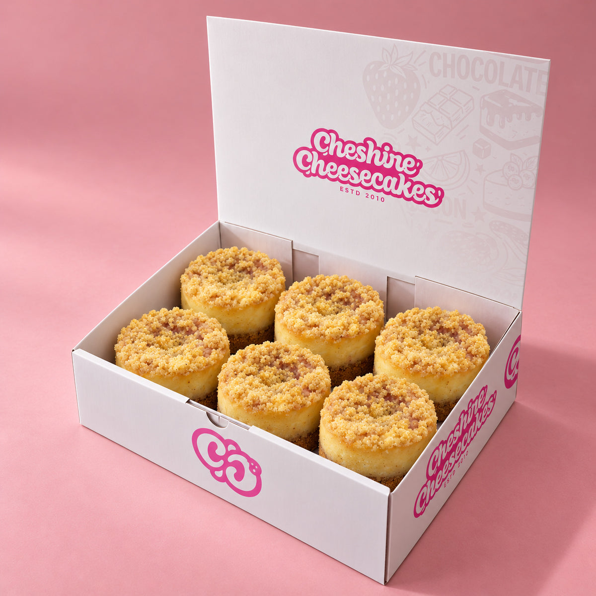 Apple & Raspberry Crumble Baked Cheesecake Box — box of 6 in blush studio, approved photographic hero
